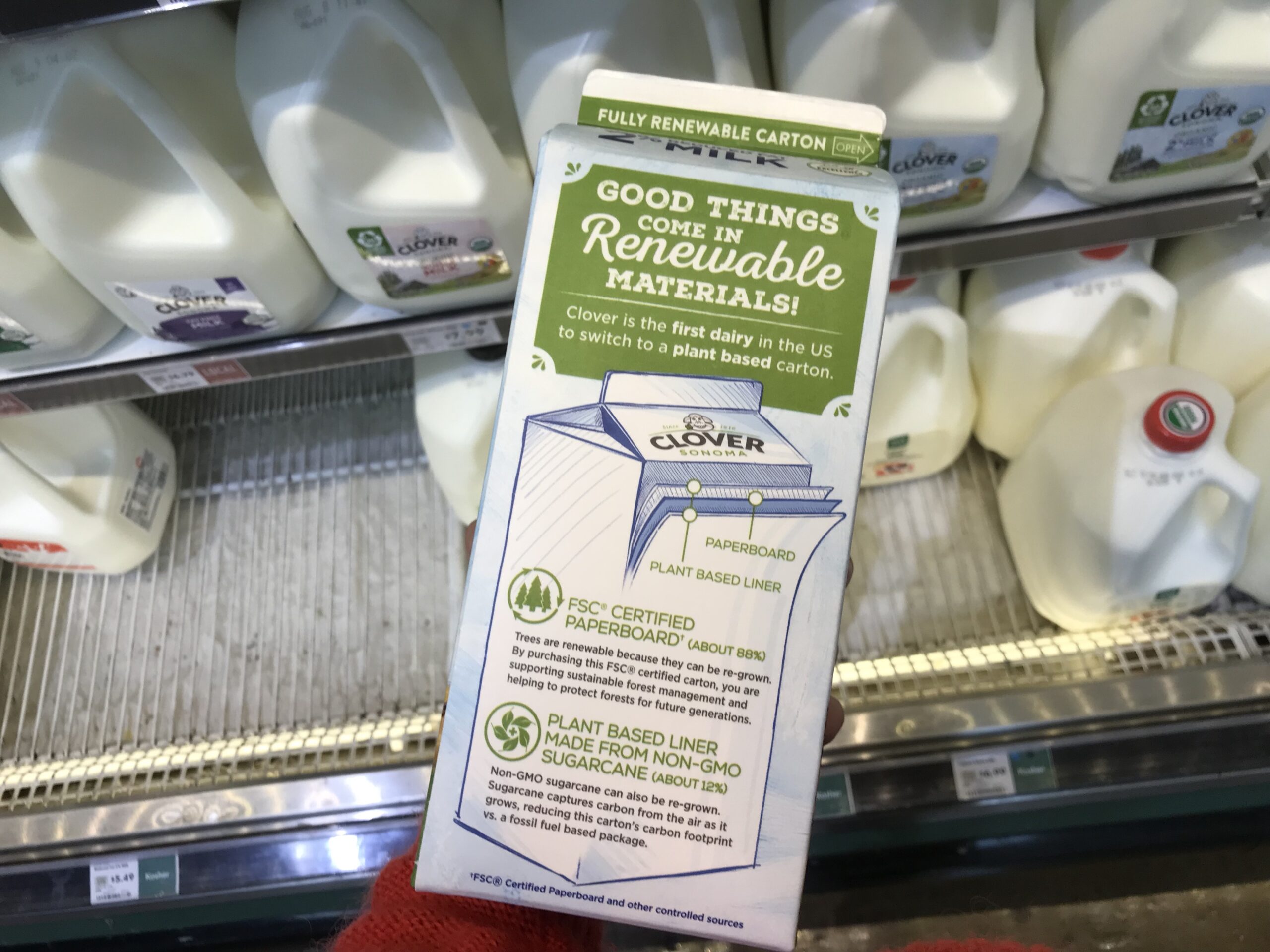 Milk carton with label that reads "Good things come in renewable materials. Clover is the first dairy in the US to switch to a plant based carton"