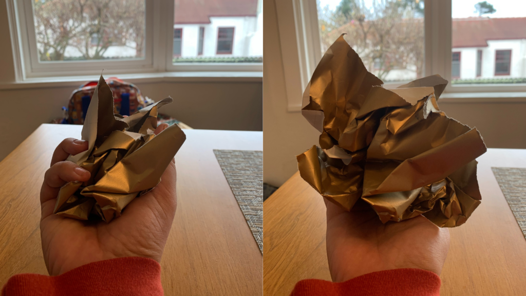 A side by side comparison of a piece of wrapping paper being crumpled up in a person's hand, and then of the person releasing their grip with the wrapping paper failing to maintain its shape.